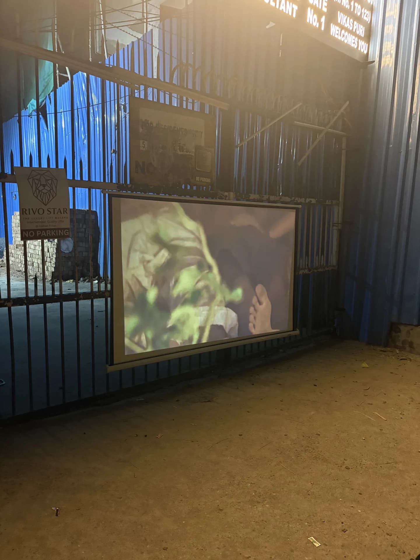 Film projected onto a screen at a community gate