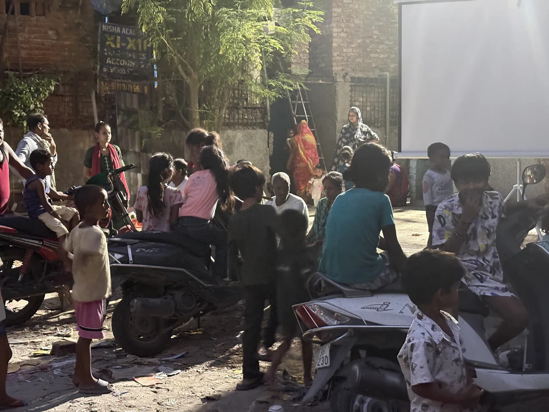 Families and neighbors arriving for a shared screening